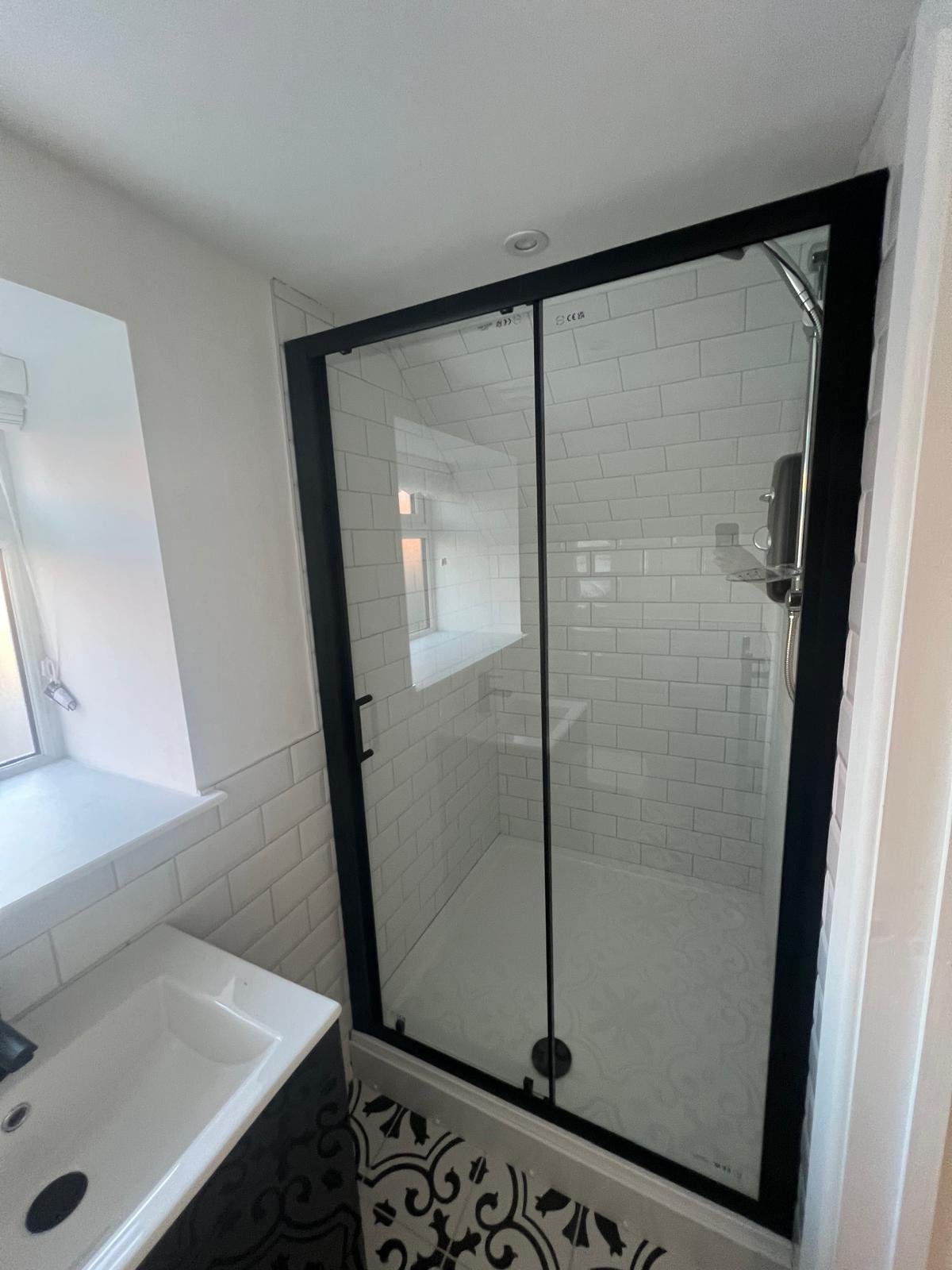 Refreshed bathroom — modern tiles and enclosure
