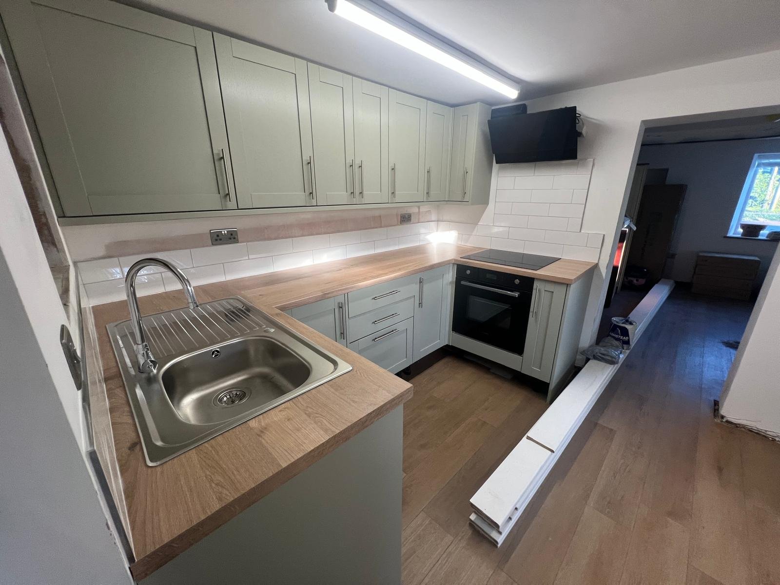 Updated kitchen — sage cabinets and induction hob